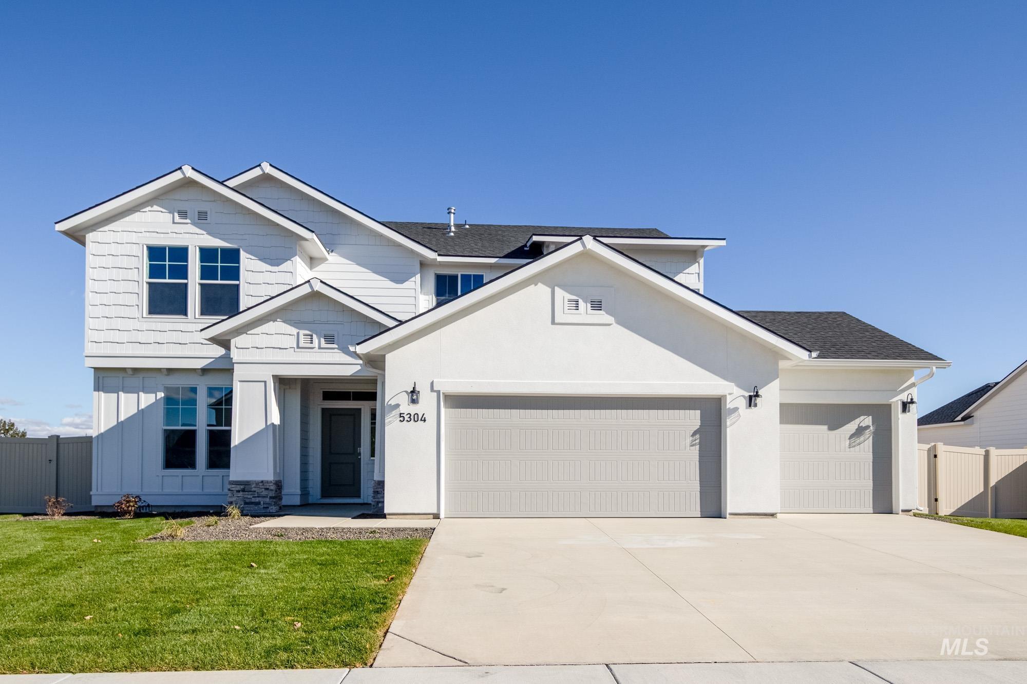 5304 Castleton Avenue Nampa, ID 83686 - Photo 1 of 25 View of front of home with concrete driveway, an attached garage, roof with shingles, stucco siding, and board and batten siding
