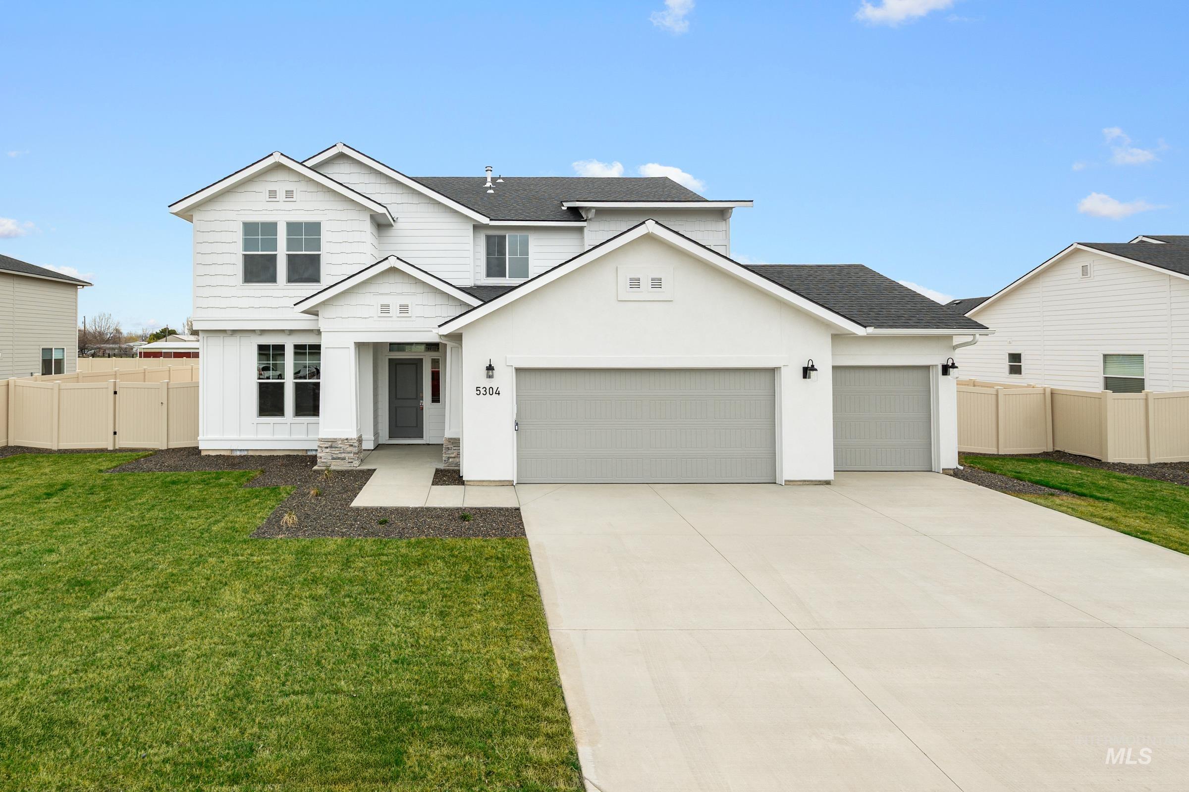 5304 Castleton Avenue Nampa, ID 83686 - Photo 1 of 1 Traditional home featuring an attached garage, driveway, a shingled roof, board and batten siding, and stucco siding