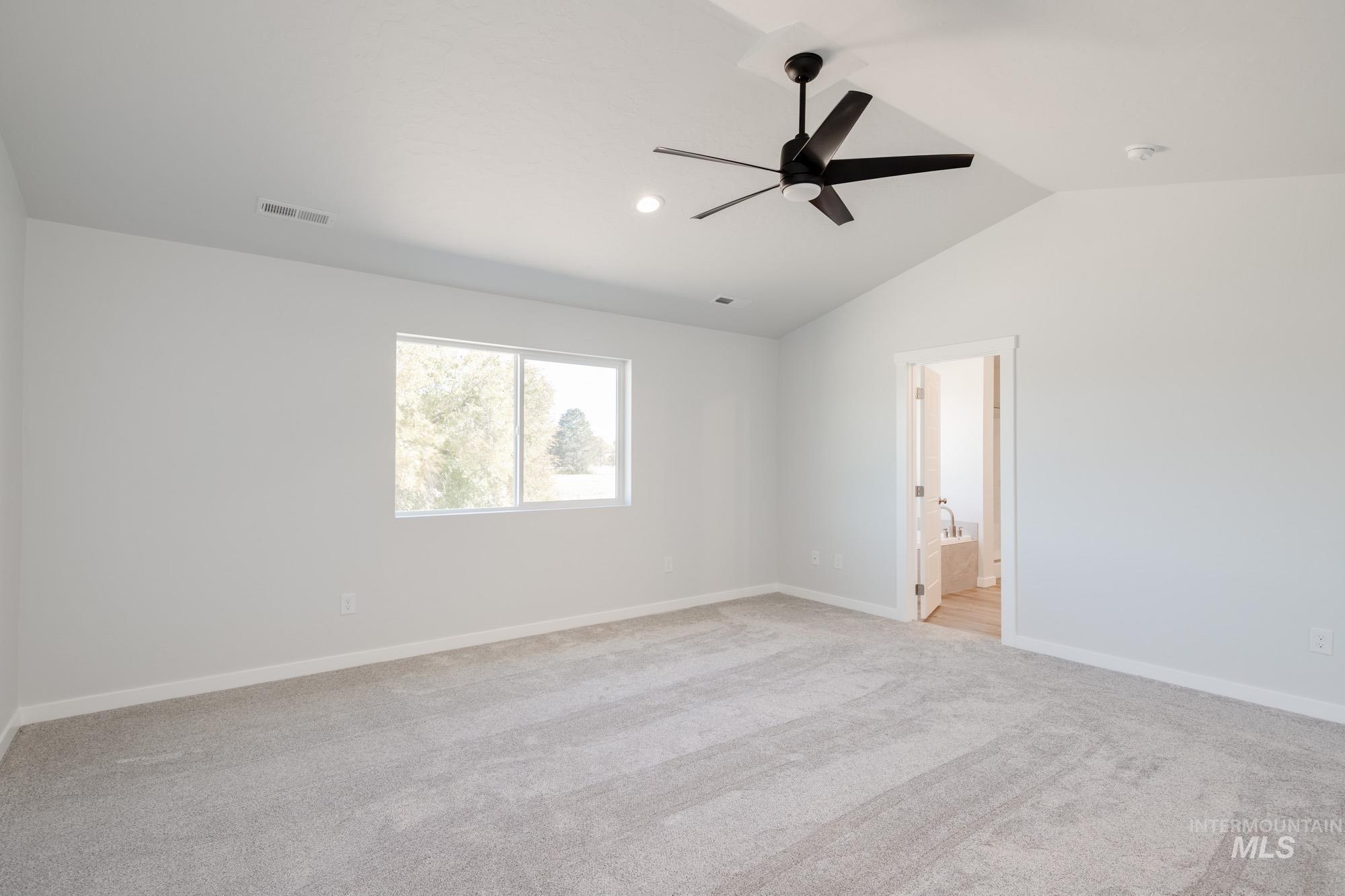 5304 Castleton Avenue Nampa, ID 83686 - Photo 17 of 25 Spare room featuring light carpet, lofted ceiling, ceiling fan, and recessed lighting