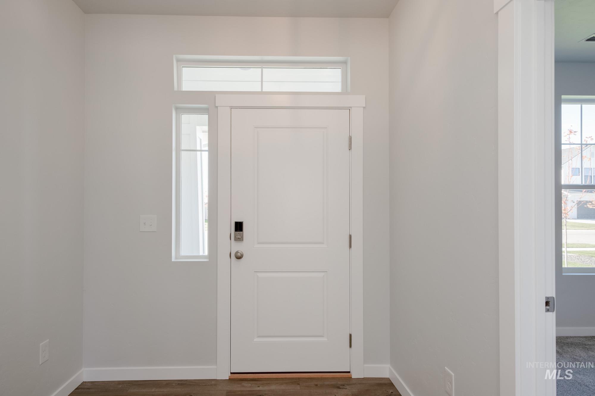 5304 Castleton Avenue Nampa, ID 83686 - Photo 2 of 25 Entrance foyer with baseboards and dark wood-style flooring