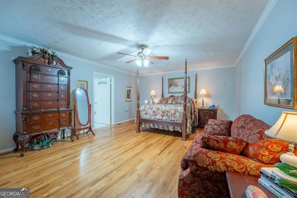 a bedroom with two beds and a chandelier