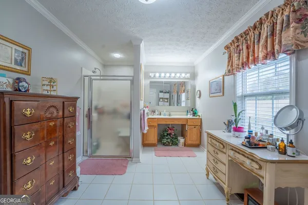 a bathroom with a sink a vanity a mirror and a shower