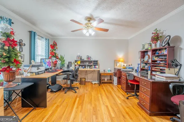 a view of a dining room with furniture a chandelier and wooden floor