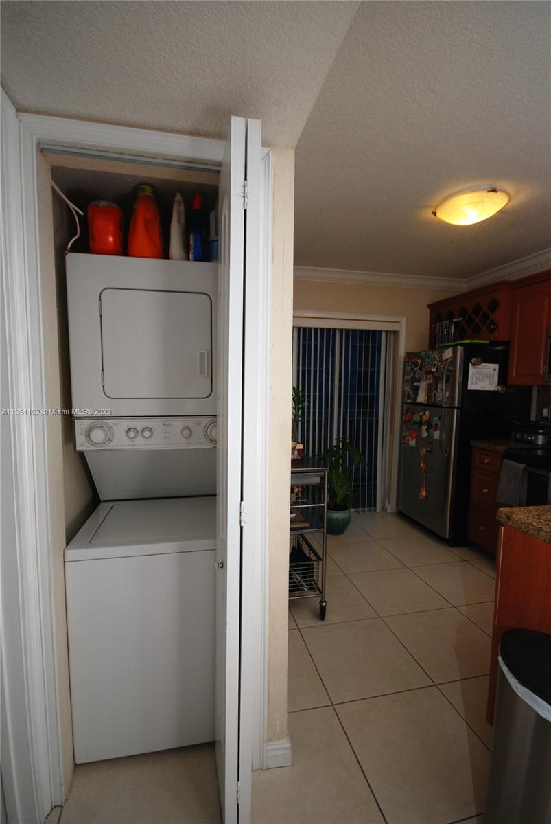 2575 Southwest 27th Avenue, Unit 409 Miami, FL 33133 - Photo 11 of 18 a utility room with dryer and washer