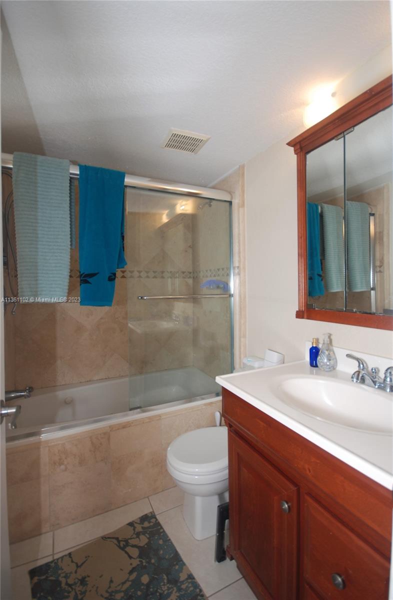 2575 Southwest 27th Avenue, Unit 409 Miami, FL 33133 - Photo 14 of 18 a bathroom with a sink a toilet and shower