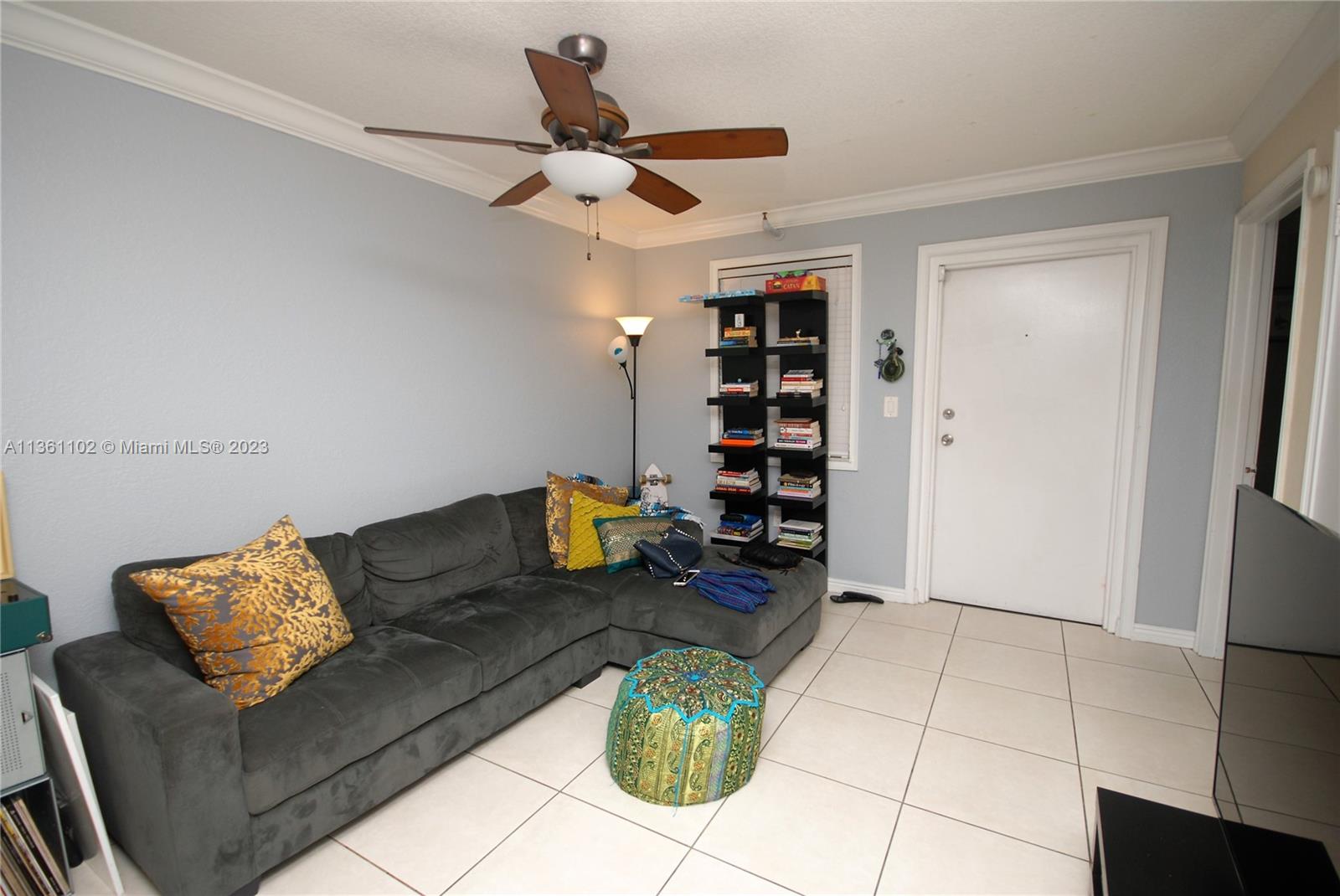 2575 Southwest 27th Avenue, Unit 409 Miami, FL 33133 - Photo 4 of 18 a living room with furniture a rug and white walls