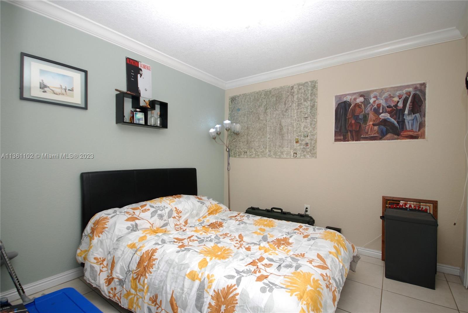 2575 Southwest 27th Avenue, Unit 409 Miami, FL 33133 - Photo 8 of 18 a bedroom with a bed and wooden floor