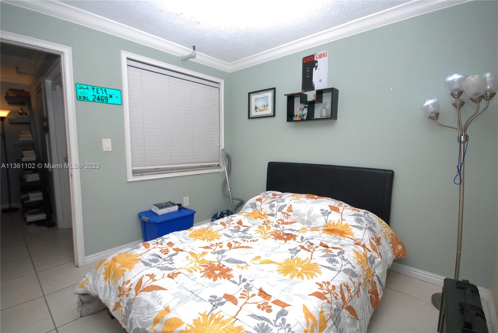 2575 Southwest 27th Avenue, Unit 409 Miami, FL 33133 - Photo 9 of 18 a bedroom with a bed and a chandelier