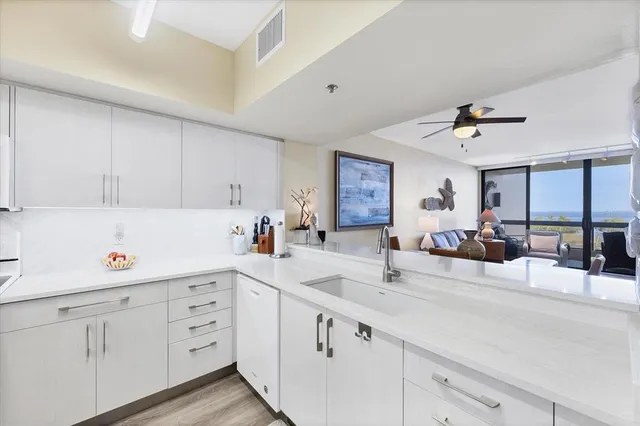 a kitchen with cabinets a sink and appliances