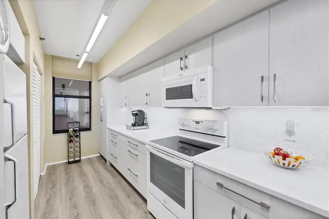 a kitchen with stainless steel appliances a cabinets and a refrigerator
