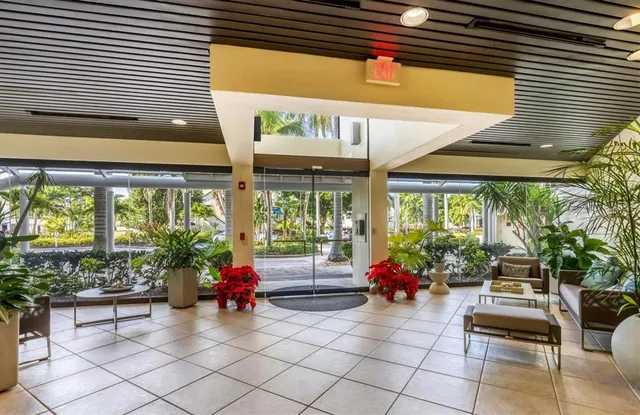 a living room filled with furniture and a potted plant