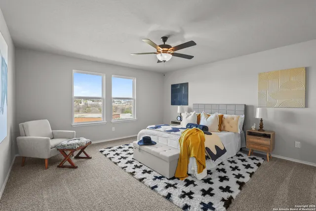 a bedroom with furniture and a window