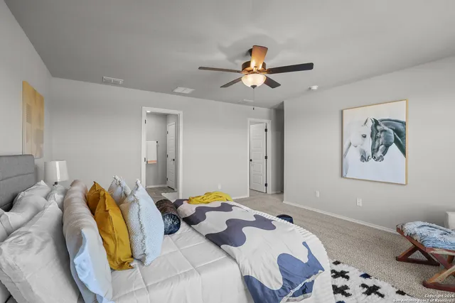 a bedroom with a bed and ceiling fan