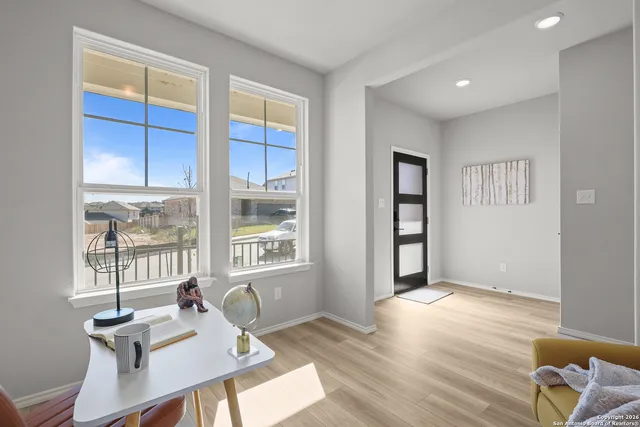 a workspace with furniture wooden floor and windows