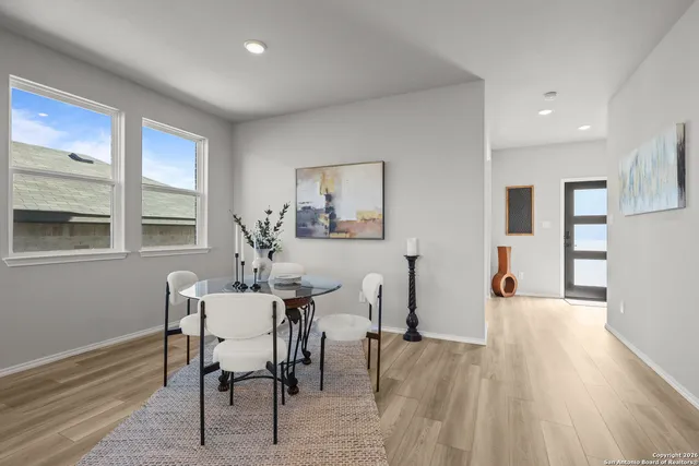 a view of a dining room with furniture and wooden floor