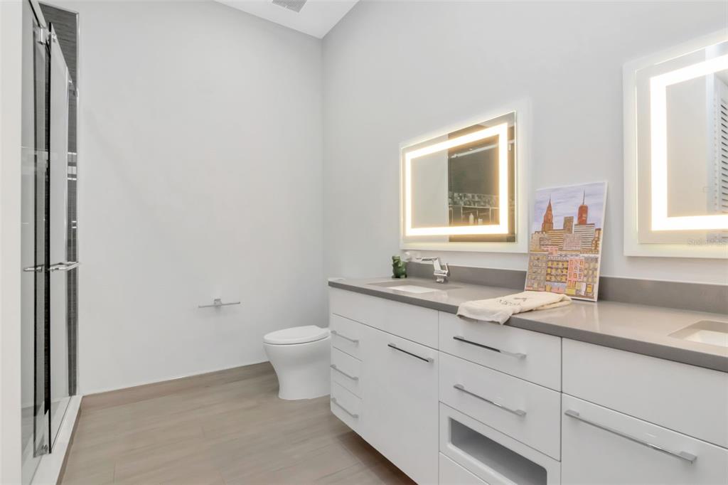 4936 West San Rafael Street Tampa, FL 33629 - Photo 24 of 42 a bathroom with a granite countertop toilet sink and mirror