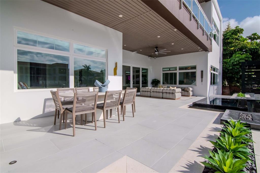 4936 West San Rafael Street Tampa, FL 33629 - Photo 36 of 42 a view of a patio with table and chairs potted plants and floor to ceiling window