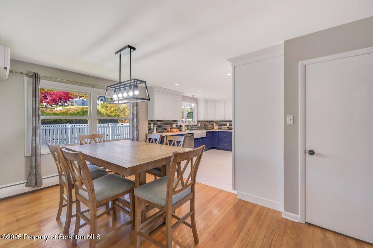 151 Primrose Avenue Clarks Summit, PA 18411 - Photo 11 of 58 a dining room with furniture wooden floor and a chandelier