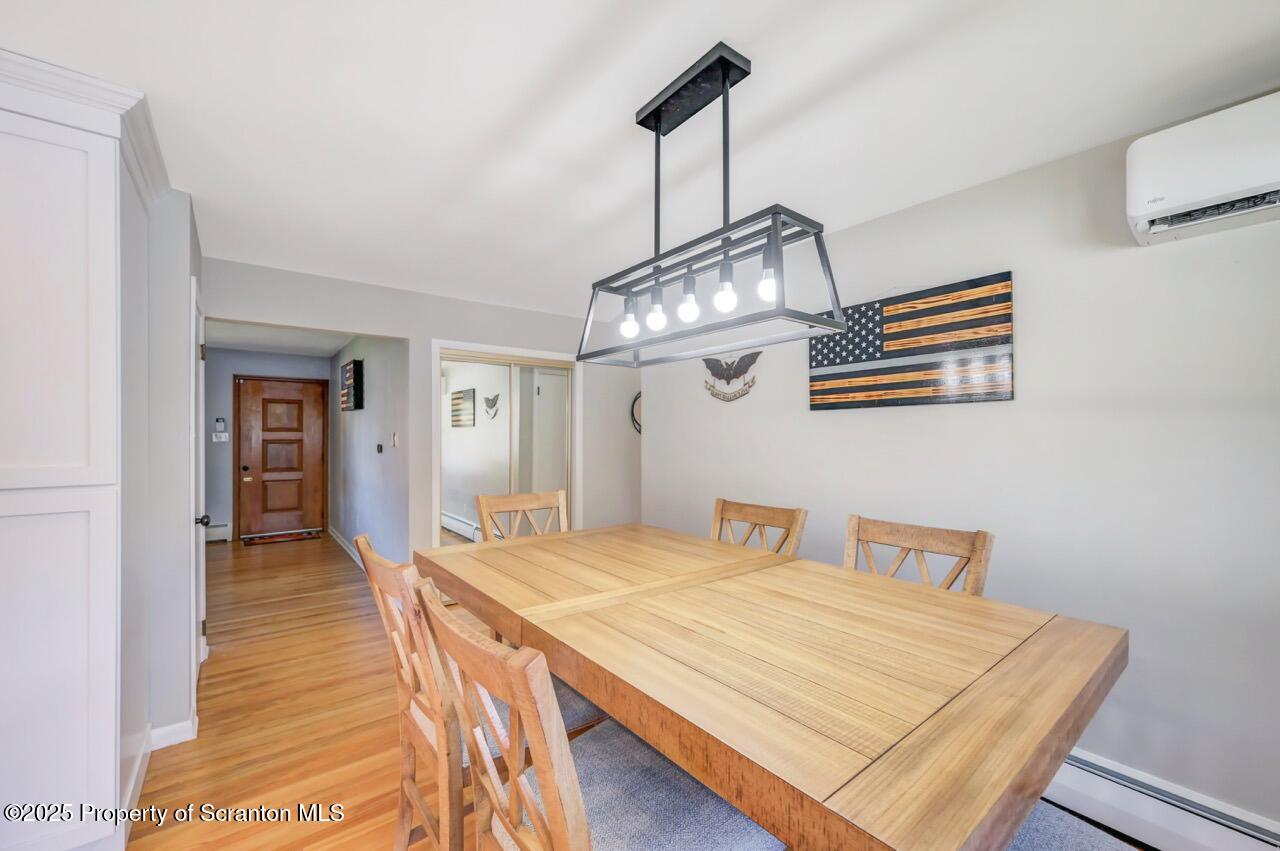 151 Primrose Avenue Clarks Summit, PA 18411 - Photo 12 of 58 a bedroom with a bed and a chandelier