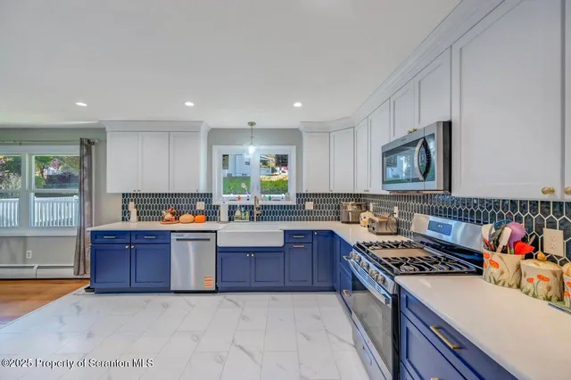 a kitchen with stainless steel appliances granite countertop a sink stove and cabinets