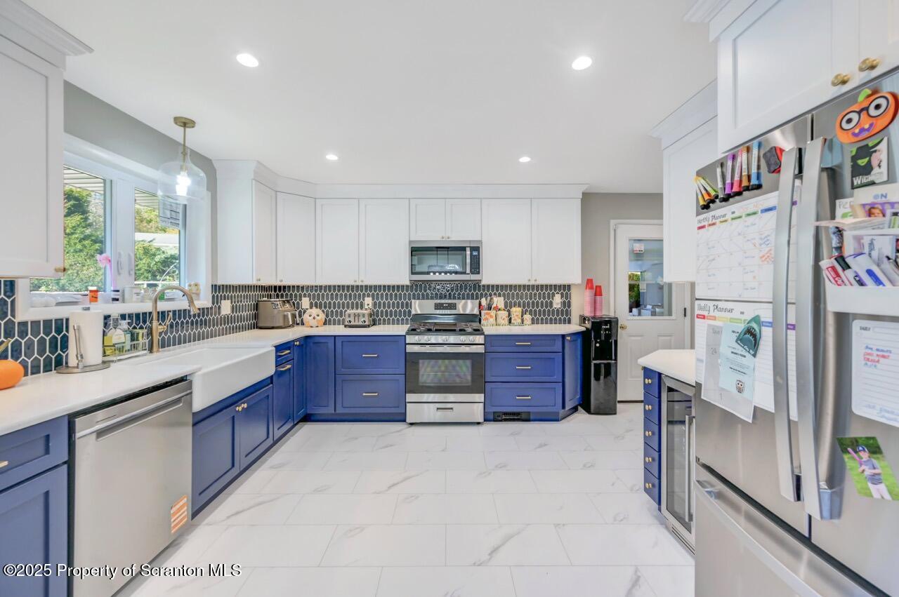 151 Primrose Avenue Clarks Summit, PA 18411 - Photo 15 of 58 a large kitchen with stainless steel appliances granite countertop a refrigerator and a stove top oven