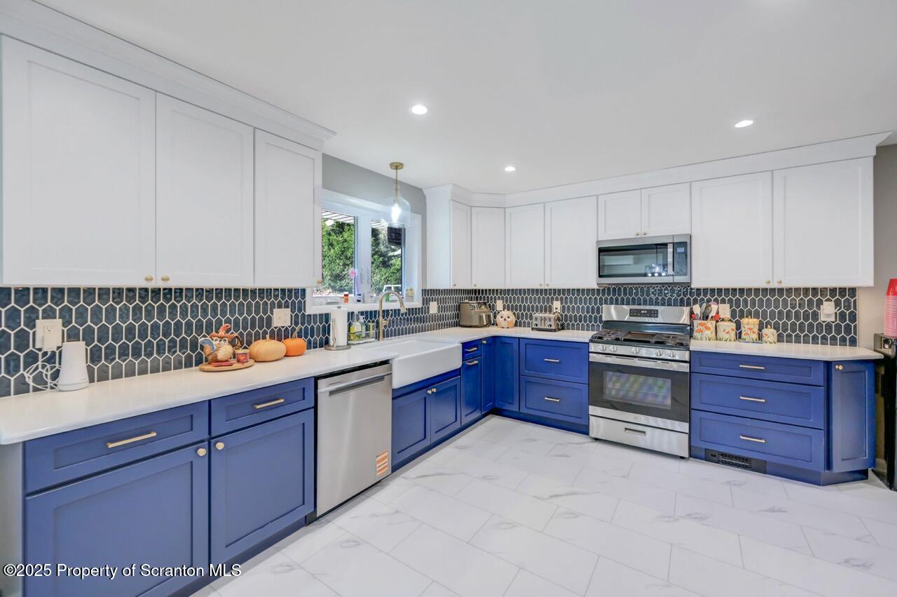 151 Primrose Avenue Clarks Summit, PA 18411 - Photo 16 of 58 a kitchen with stainless steel appliances granite countertop a stove and a sink