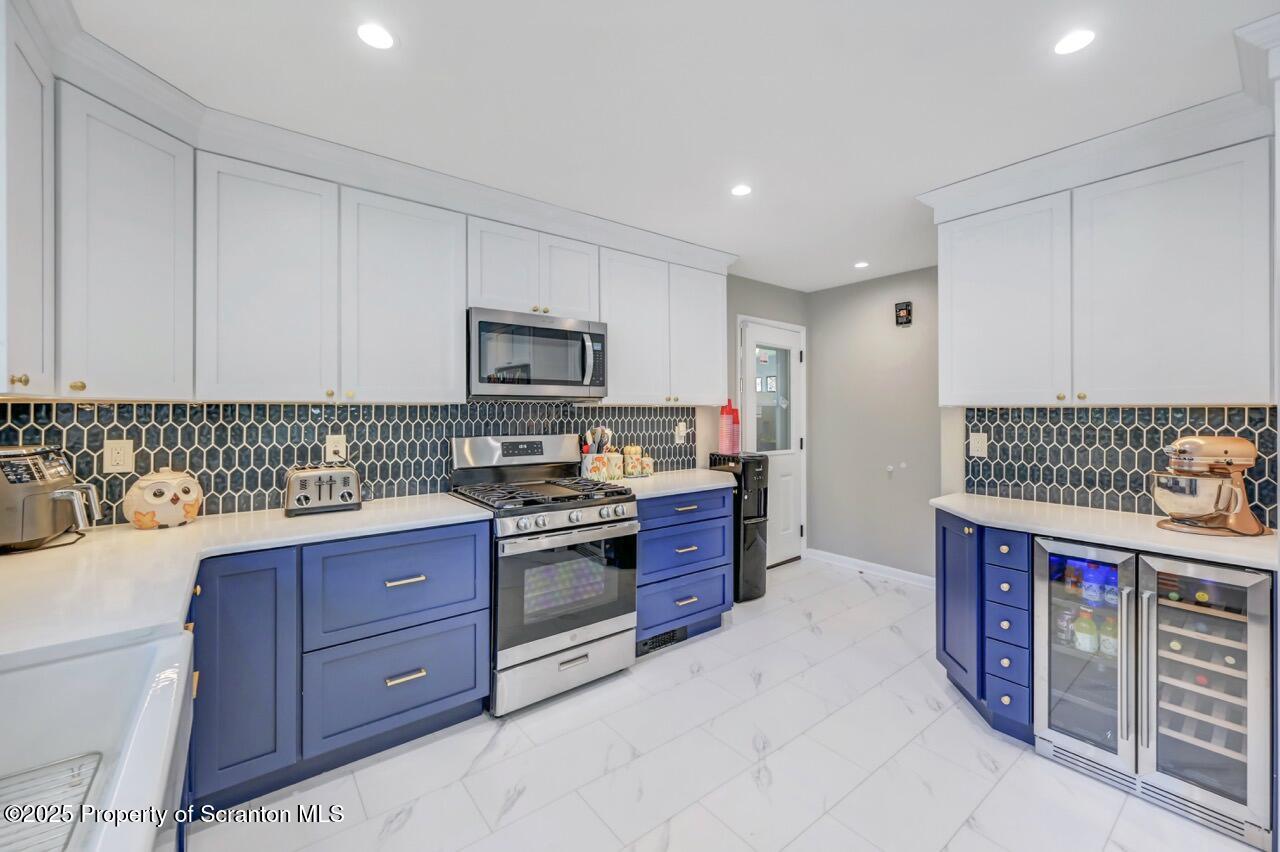 151 Primrose Avenue Clarks Summit, PA 18411 - Photo 18 of 58 a kitchen with stainless steel appliances granite countertop a stove and a sink