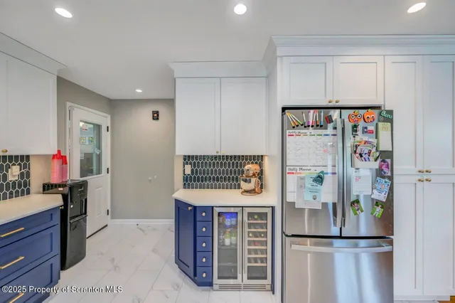 a kitchen with stainless steel appliances granite countertop a refrigerator and a stove top oven