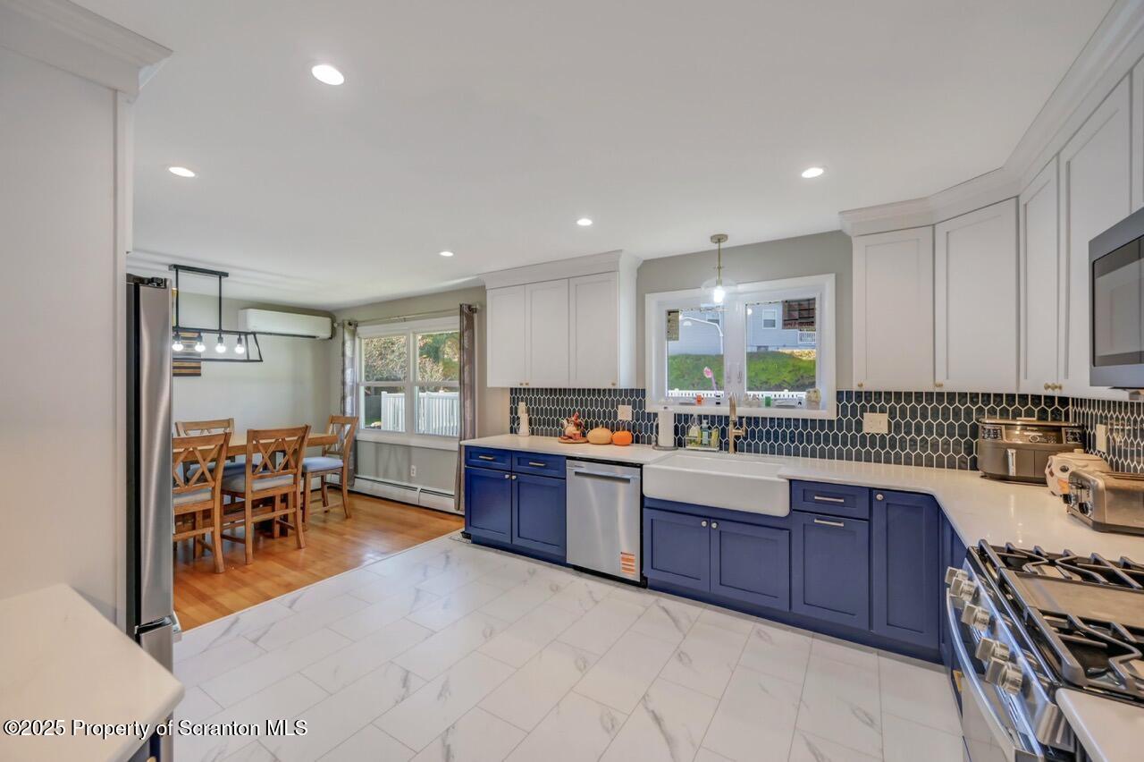 151 Primrose Avenue Clarks Summit, PA 18411 - Photo 22 of 58 a kitchen with lots of counter top space and stainless steel appliances