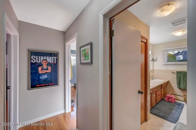 a view of a hallway with workspace and a living room