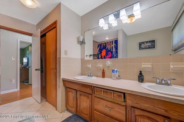 a bathroom with a sink double vanity and a mirror