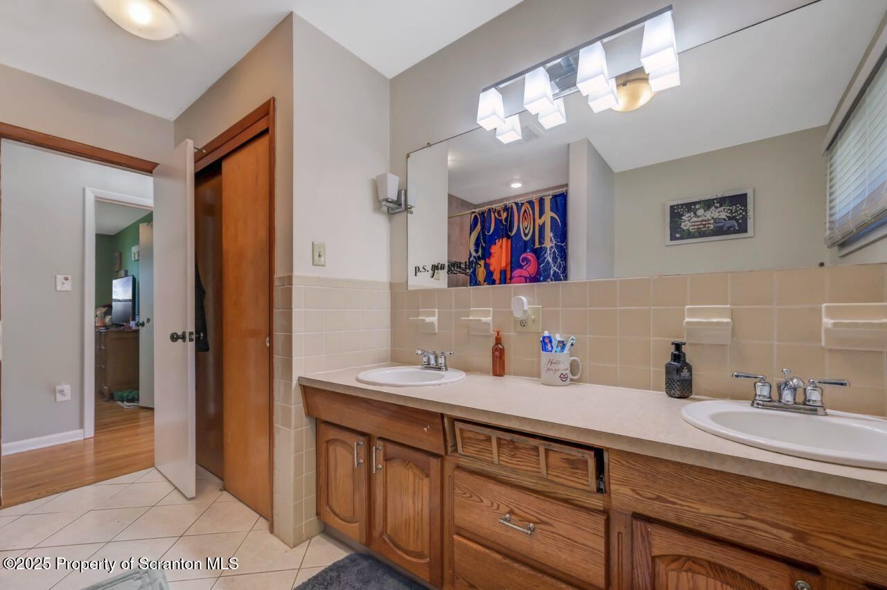 151 Primrose Avenue Clarks Summit, PA 18411 - Photo 29 of 58 a bathroom with a sink double vanity and a mirror