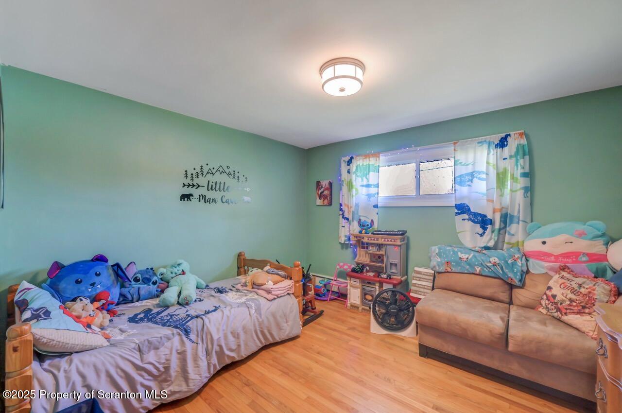 151 Primrose Avenue Clarks Summit, PA 18411 - Photo 33 of 58 a bedroom with furniture and a wooden floor
