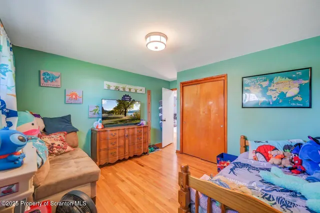 a bedroom with a bed workspace and a window