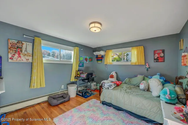 a bed room with a bed mirror and a dresser