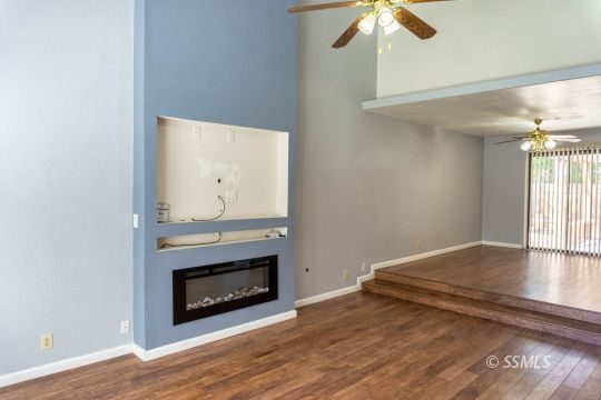 316 Mesquite Avenue Ridgecrest, CA 93555 - Photo 9 of 38 a view of empty room with wooden floor and fireplace