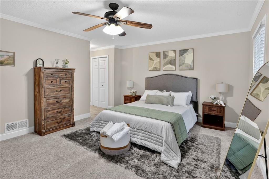 90 Hoglen Drive Covington, GA 30016 - Photo 13 of 28 a bedroom with a bed and a chair