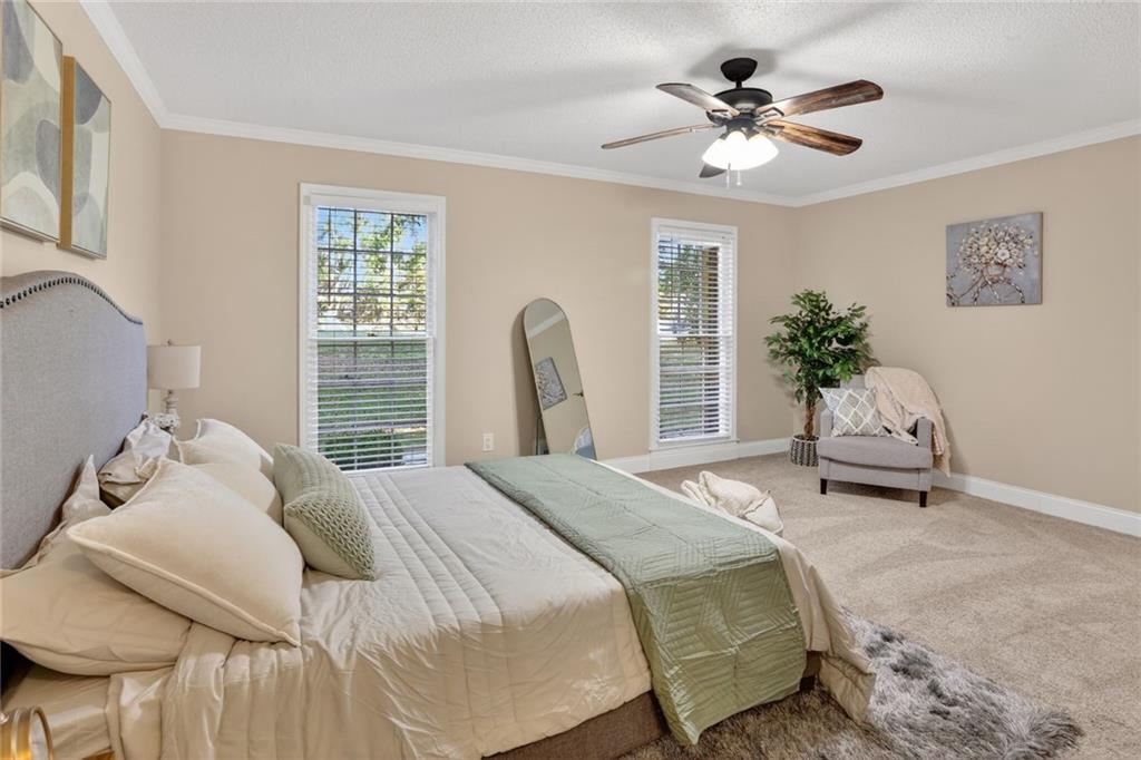 90 Hoglen Drive Covington, GA 30016 - Photo 15 of 28 a bedroom with a bed and a chandelier