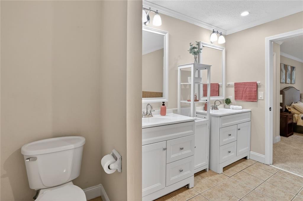 90 Hoglen Drive Covington, GA 30016 - Photo 16 of 28 a bathroom with a toilet sink and mirror