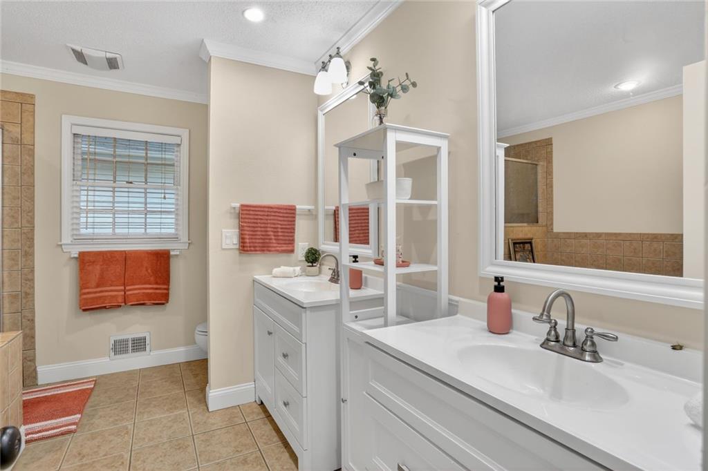 90 Hoglen Drive Covington, GA 30016 - Photo 17 of 28 a bathroom with a sink double vanity and a mirror
