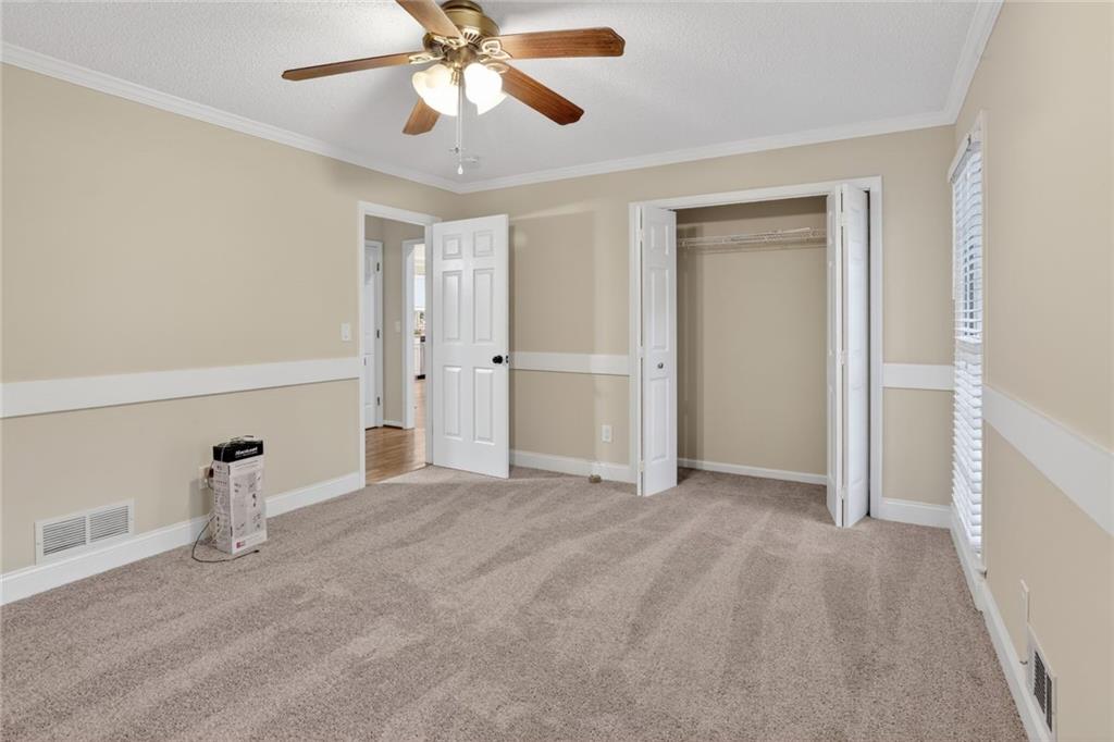 90 Hoglen Drive Covington, GA 30016 - Photo 20 of 28 a view of empty room with wooden floor and fan