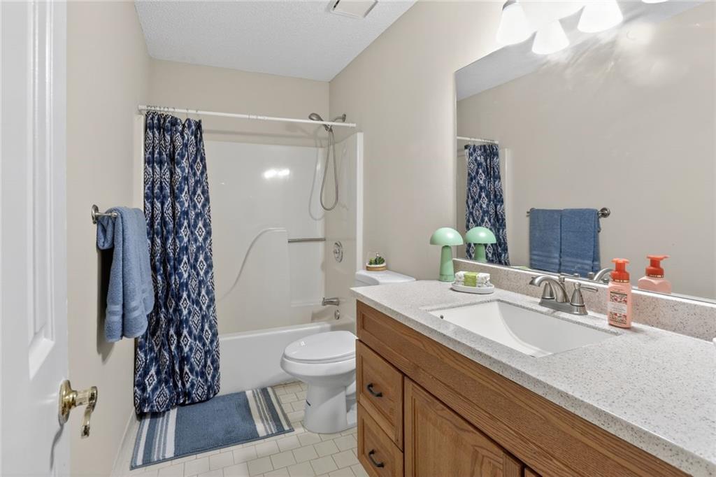 90 Hoglen Drive Covington, GA 30016 - Photo 23 of 28 a bathroom with a sink a toilet and shower