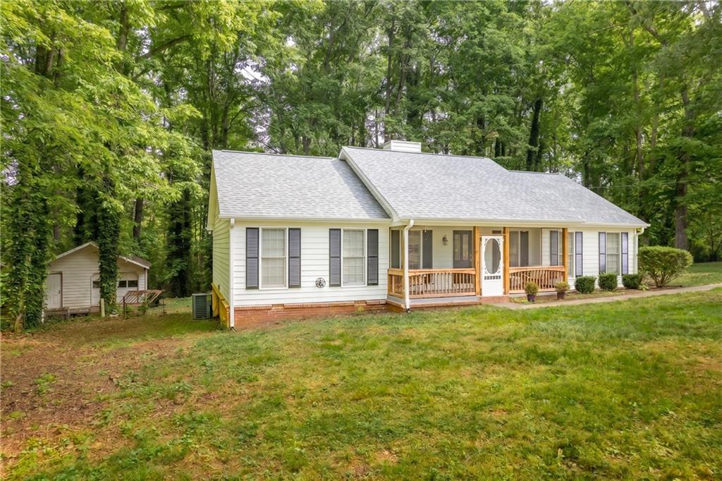 90 Hoglen Drive Covington, GA 30016 - Photo 28 of 28 a view of a house with a big yard and large trees