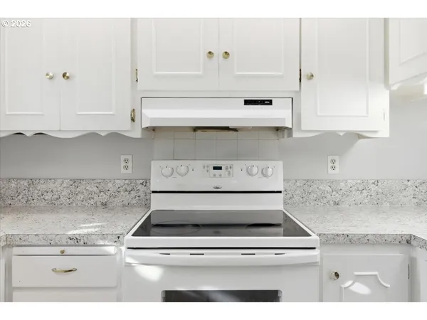 a stove top oven sitting inside of a kitchen