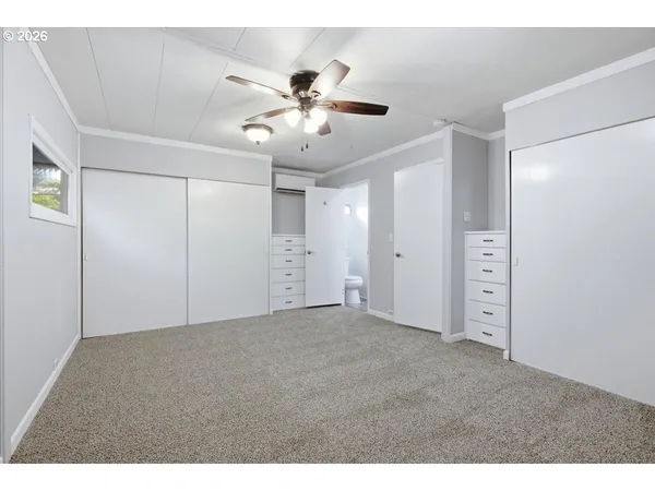 a view of an empty room with a ceiling fan