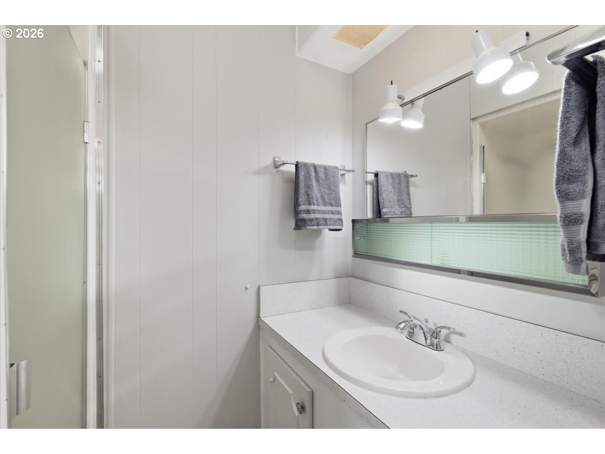 5422 Portland Road Northeast, Unit 33 Salem, OR 97305 - Photo 17 of 28 a bathroom with a sink and a mirror