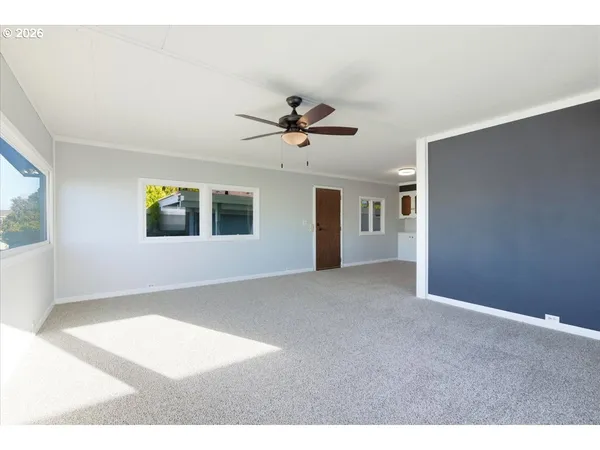 a view of a livingroom with a ceiling fan and window