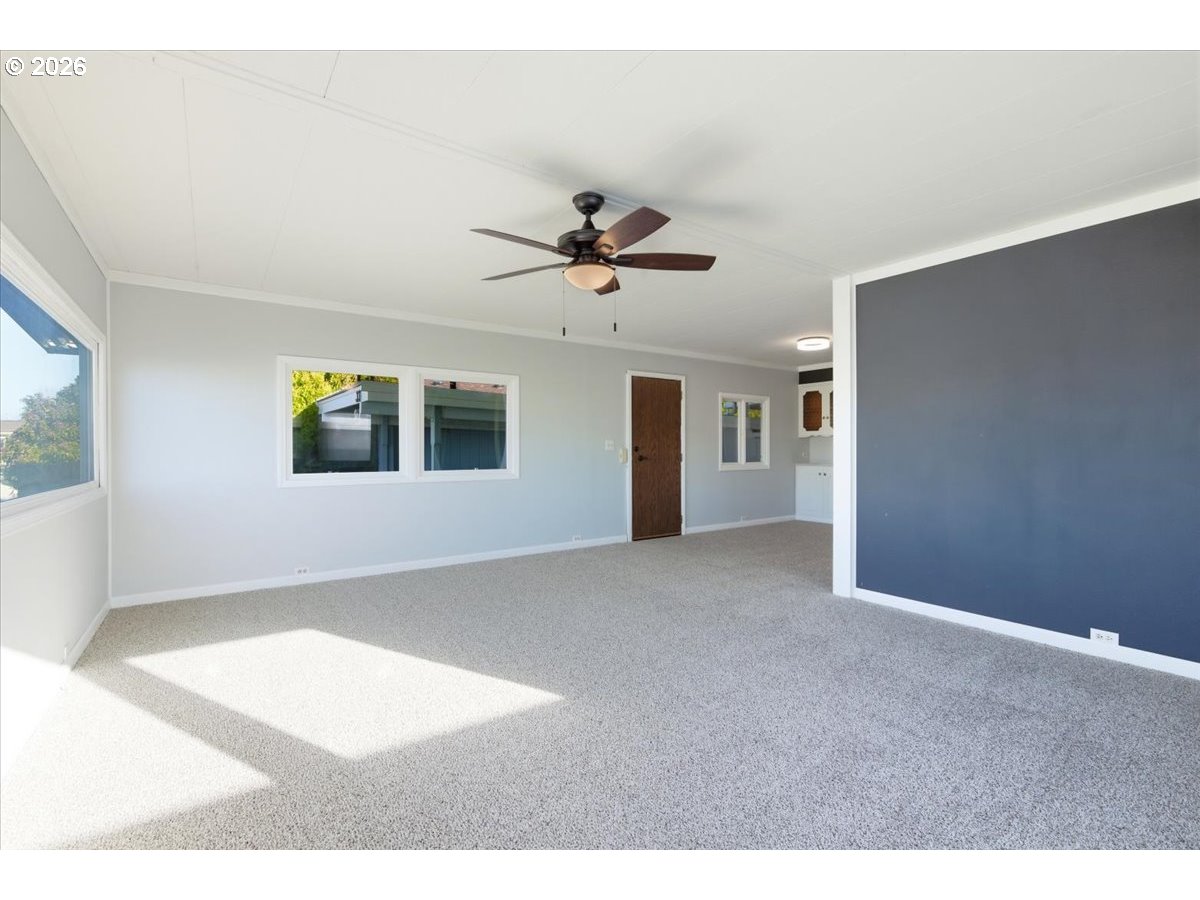5422 Portland Road Northeast, Unit 33 Salem, OR 97305 - Photo 4 of 28 a view of a livingroom with a ceiling fan and window