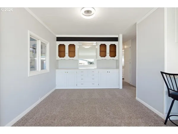 a view of kitchen with wooden cabinet