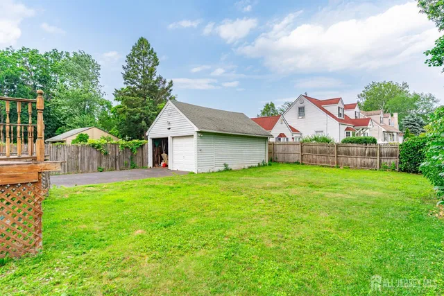 a view of house with backyard and garden